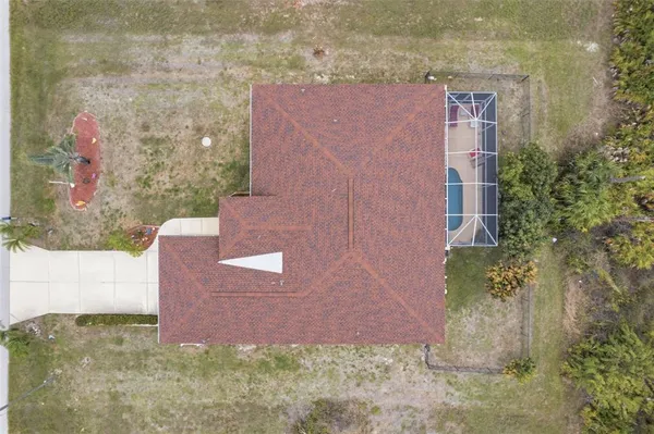 front view of a brick house with a yard