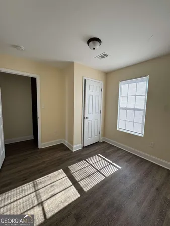 wooden floor in an empty room with a window