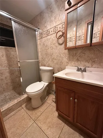 a bathroom with a sink a toilet and a shower