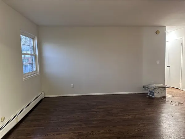 a view of an empty room and wooden floor