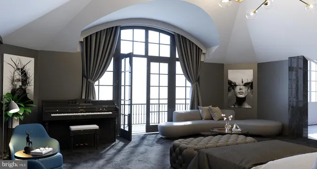 a living room with furniture and a floor to ceiling window