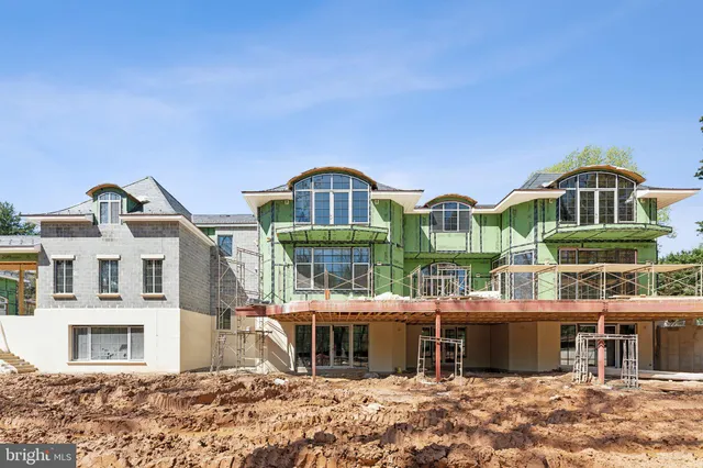 a front view of a residential apartment building with a yard
