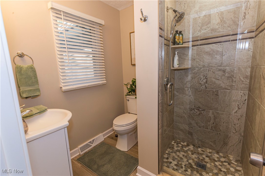 2430 Rockside Road Independence, OH 44131 - Photo 19 of 46 Bathroom featuring vanity, a shower stall, and wood finished floors