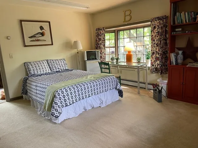 a bed room with a bed and a chair