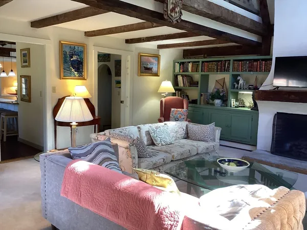 a living room with furniture and a chandelier
