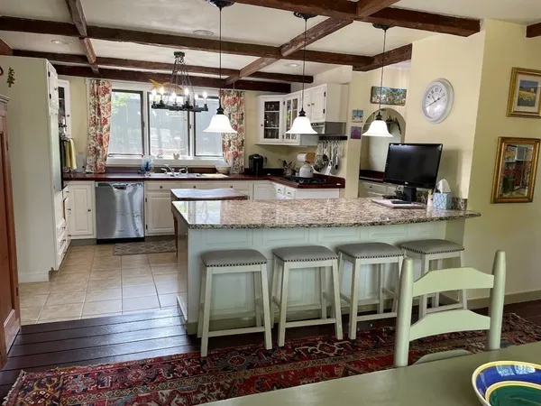 a kitchen with stainless steel appliances granite countertop a sink and wooden cabinets