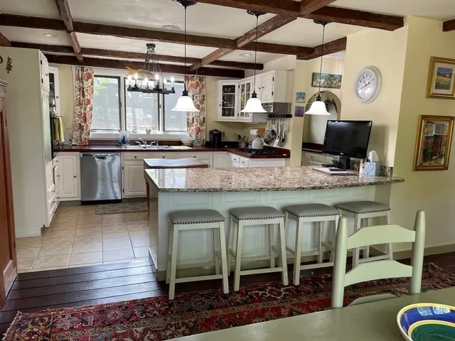 a kitchen with stainless steel appliances granite countertop a sink and wooden cabinets