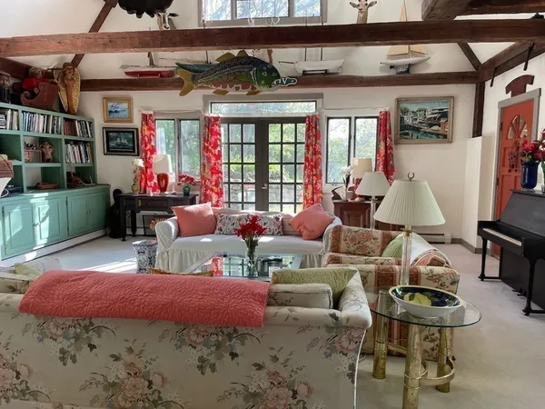 a bedroom with a bed table and a chandelier