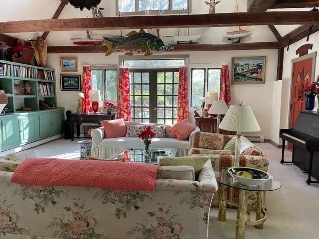 a bedroom with a bed table and a chandelier