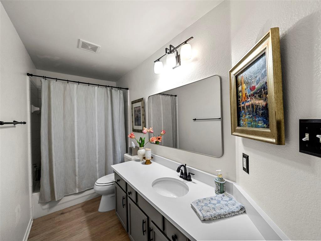 204 Arbor Ridge Drive Allen, TX 75002 - Photo 23 of 36 Bathroom featuring a single vanity with dark gray cabinetry, a white countertop, and a matte black faucet
