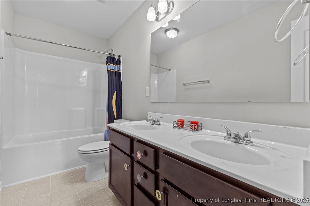 251 Crane Way Bunnlevel, NC 28323 - Photo 11 of 49 a bathroom with a sink a toilet a mirror and shower