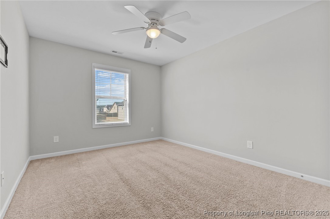 251 Crane Way Bunnlevel, NC 28323 - Photo 14 of 49 an empty room with a window and a fan