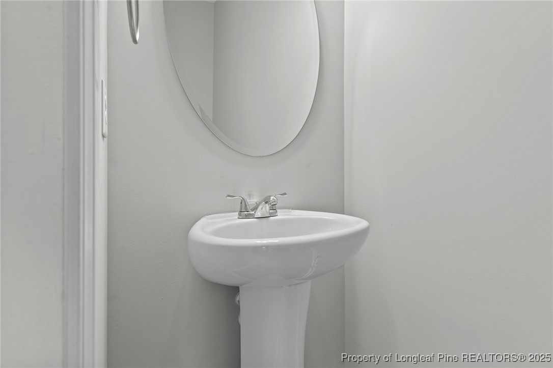 251 Crane Way Bunnlevel, NC 28323 - Photo 26 of 49 a bathroom with a sink and a mirror