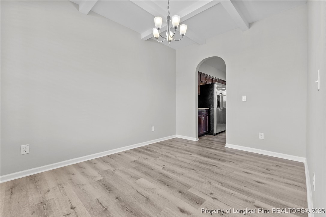 251 Crane Way Bunnlevel, NC 28323 - Photo 27 of 49 a view of an empty room with a chandelier fan