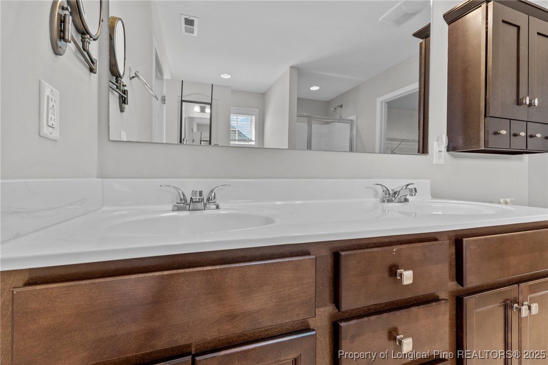 251 Crane Way Bunnlevel, NC 28323 - Photo 6 of 49 a bathroom with a sink a mirror and vanity