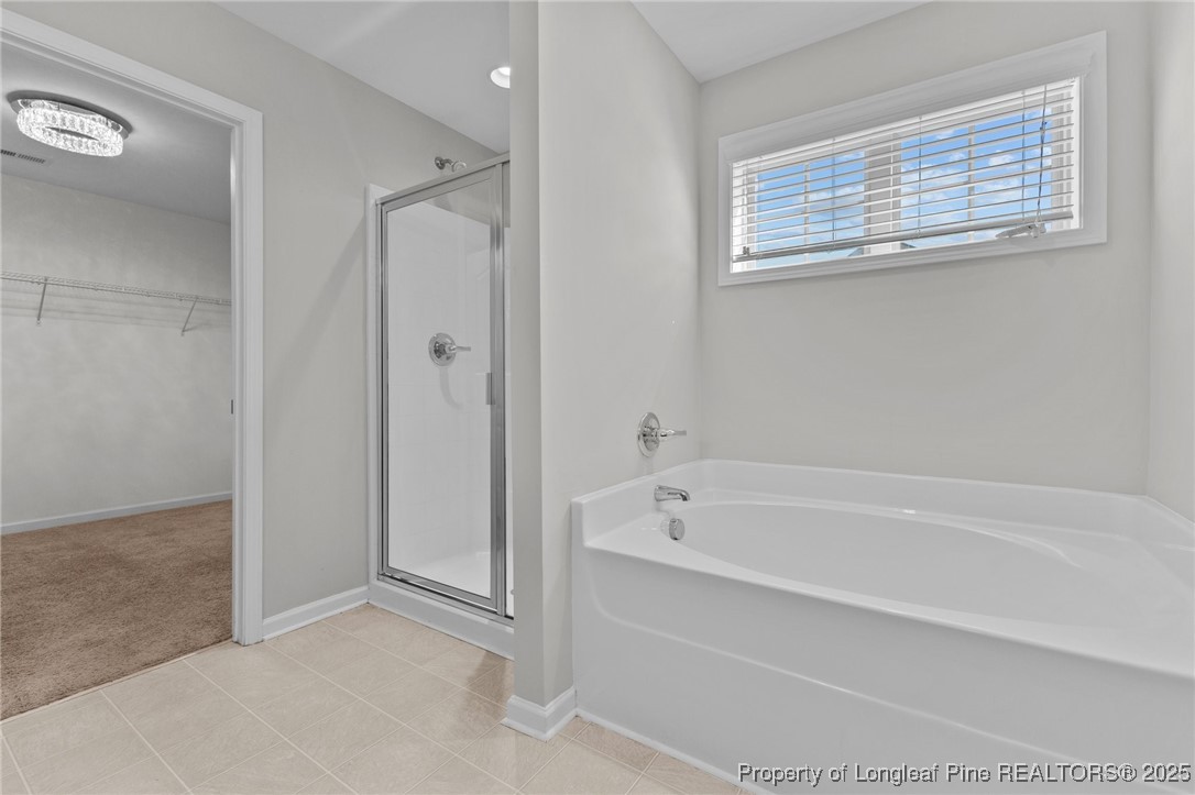 251 Crane Way Bunnlevel, NC 28323 - Photo 7 of 49 a spacious bathroom with a bathtub and a shower
