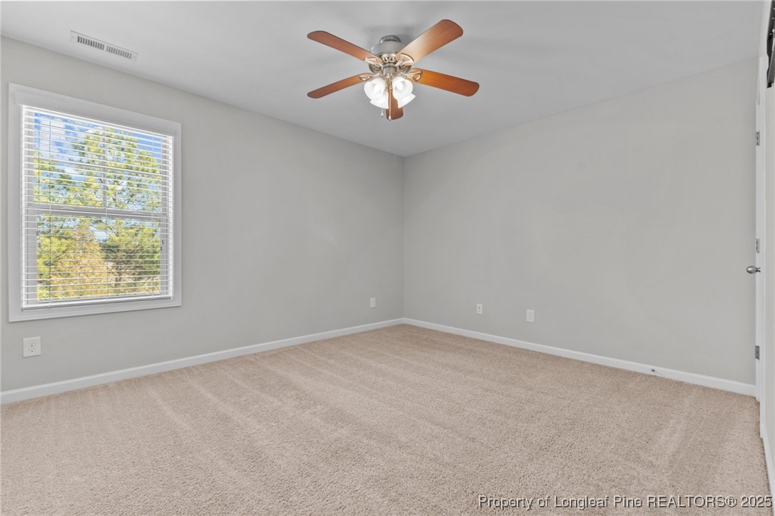 251 Crane Way Bunnlevel, NC 28323 - Photo 9 of 49 an empty room with a window and a fan