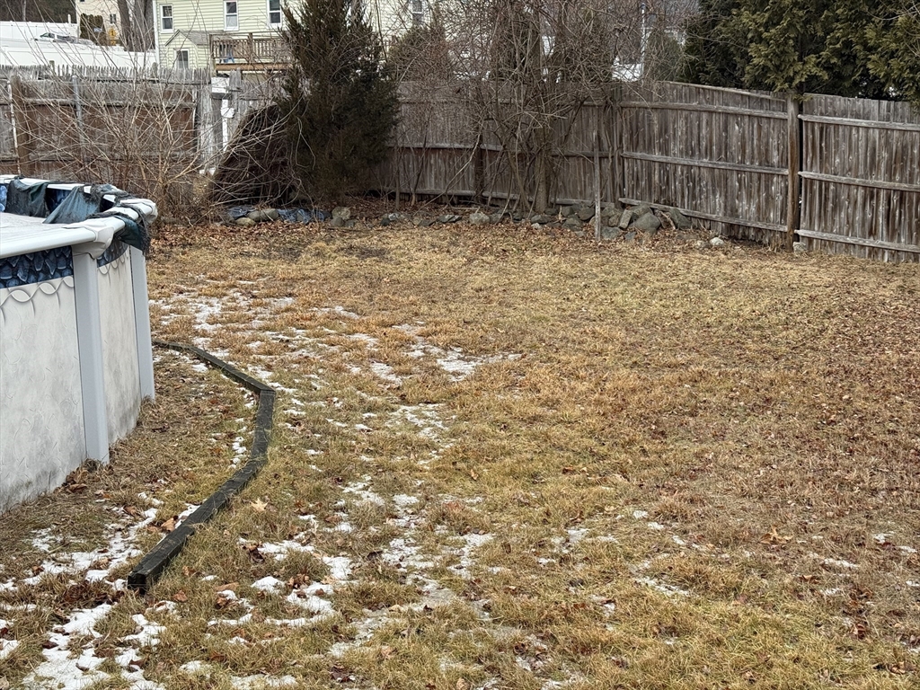 6 Anthony Road Tewksbury, MA 01876 - Photo 12 of 31 a view of a backyard with wooden fence