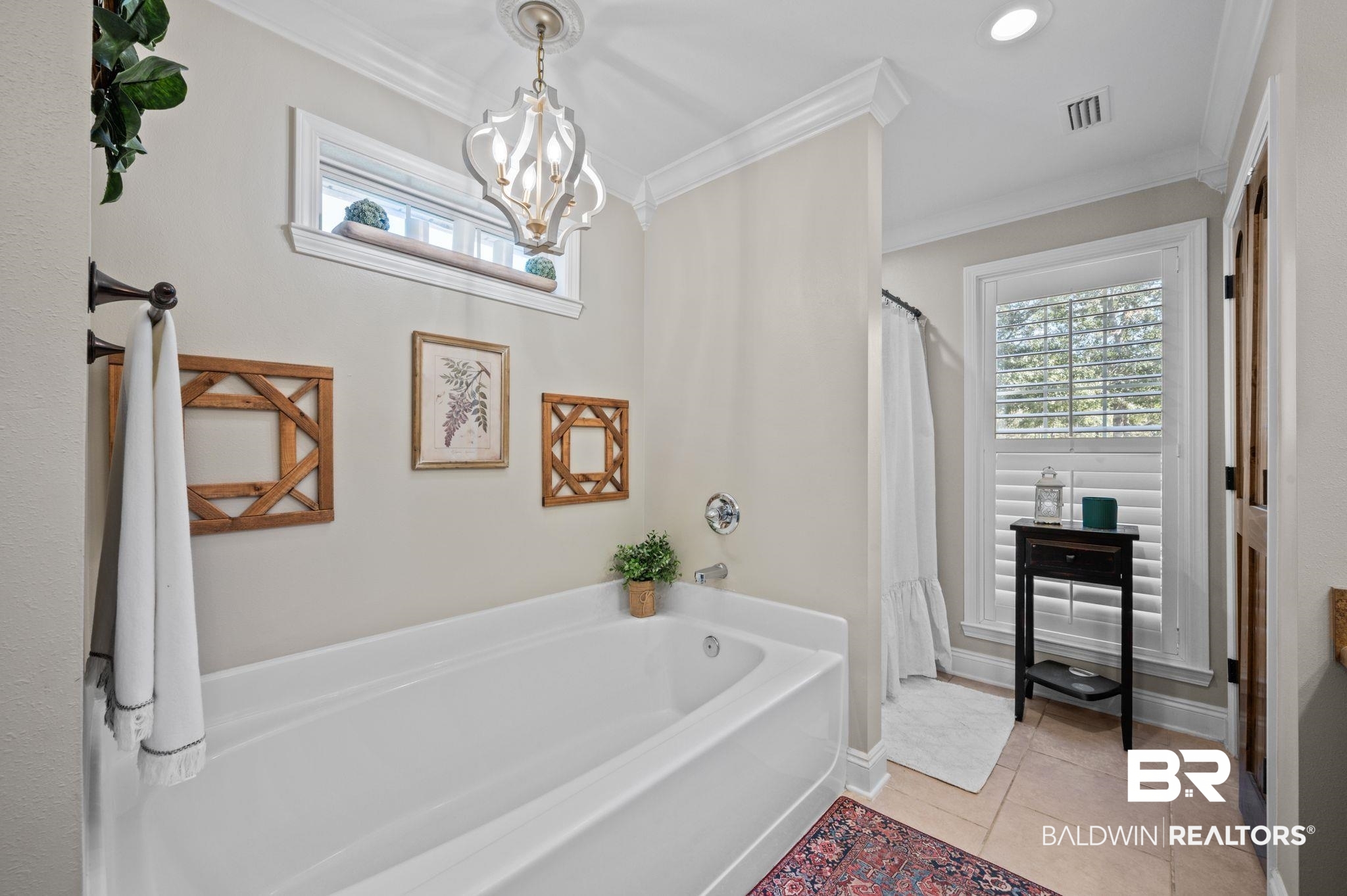 38211-d) V R Byrd Road Bay Minette, AL 36507 - Photo 21 of 58 Bathroom featuring a chandelier, a tub to relax in, tile patterned floors, and crown molding