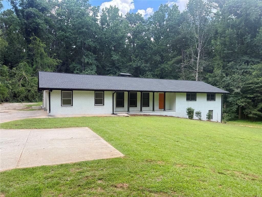 4330 Stonewall Tell Road Atlanta, GA 30349 - Photo 38 of 39 a front view of a house with a garden