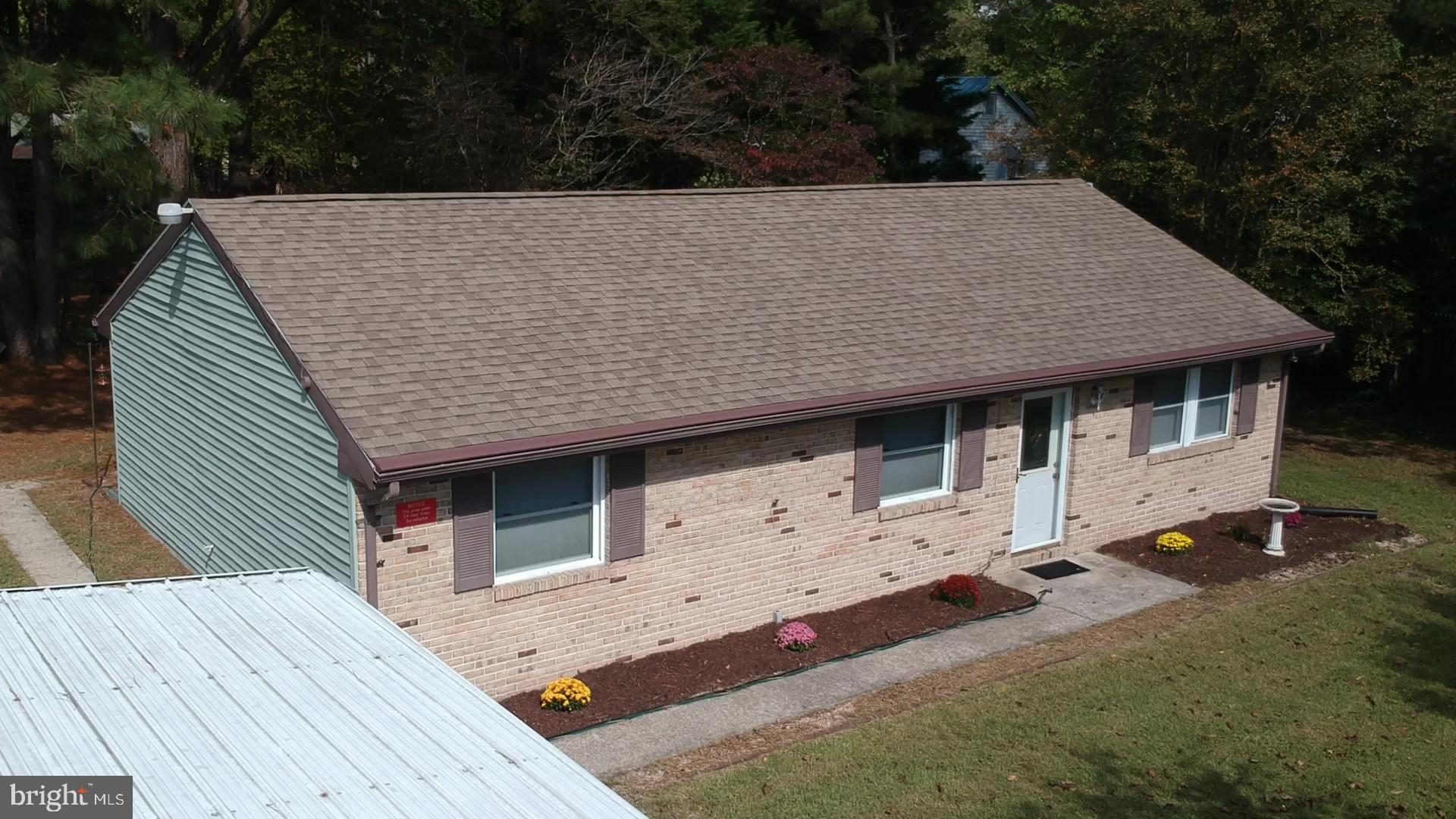 a terrace with wooden fence and outdoor seating