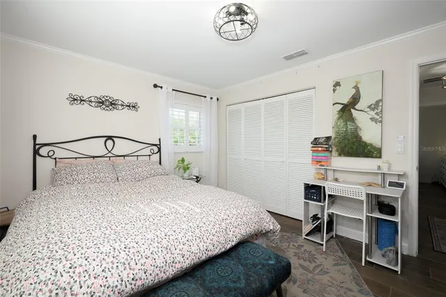 a bedroom with a bed and a window