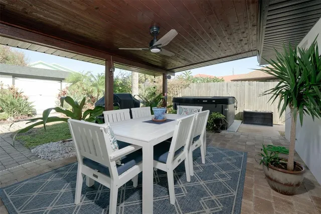 a view of a patio with a table chairs and a potted plant