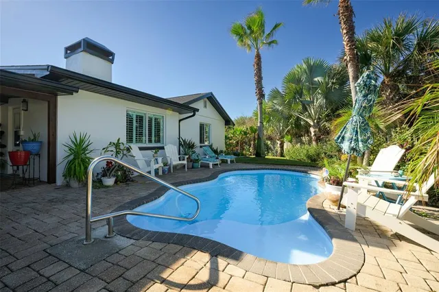 a view of a swimming pool with a patio