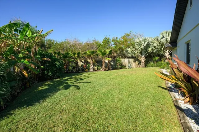 an aerial view of a house with a yard and garden