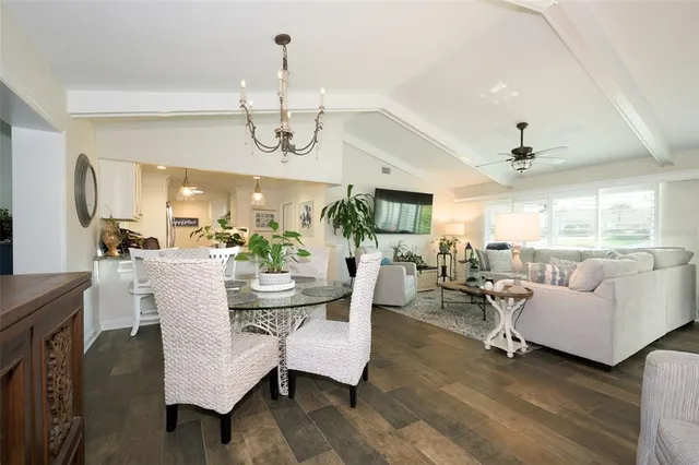 a living room with fireplace furniture and a chandelier