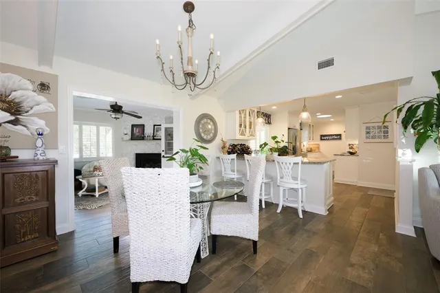 a view of a dining room with furniture a chandelier and wooden floor