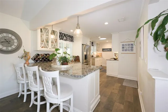 a dining room with furniture and a large window