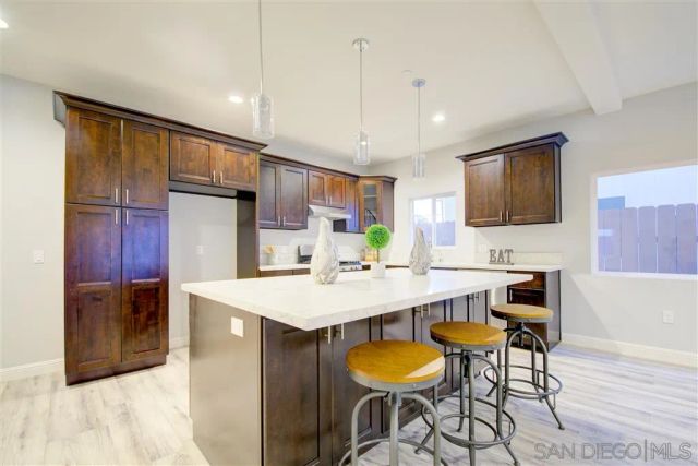 a large kitchen with a table and chairs