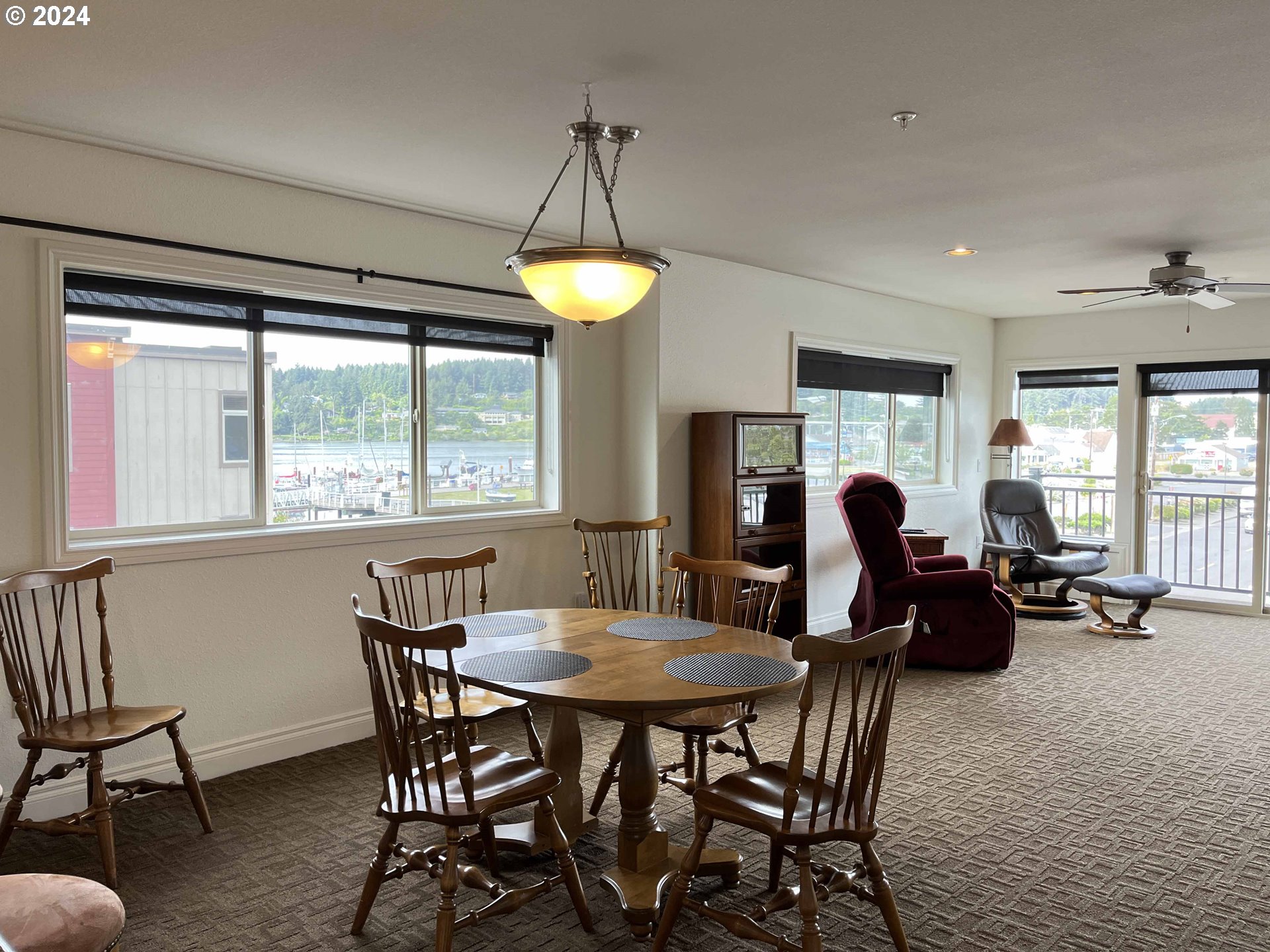 211 Harbor Street, Unit 31 Florence, OR 97439 - Photo 11 of 44 a dining room with furniture a chandelier and window