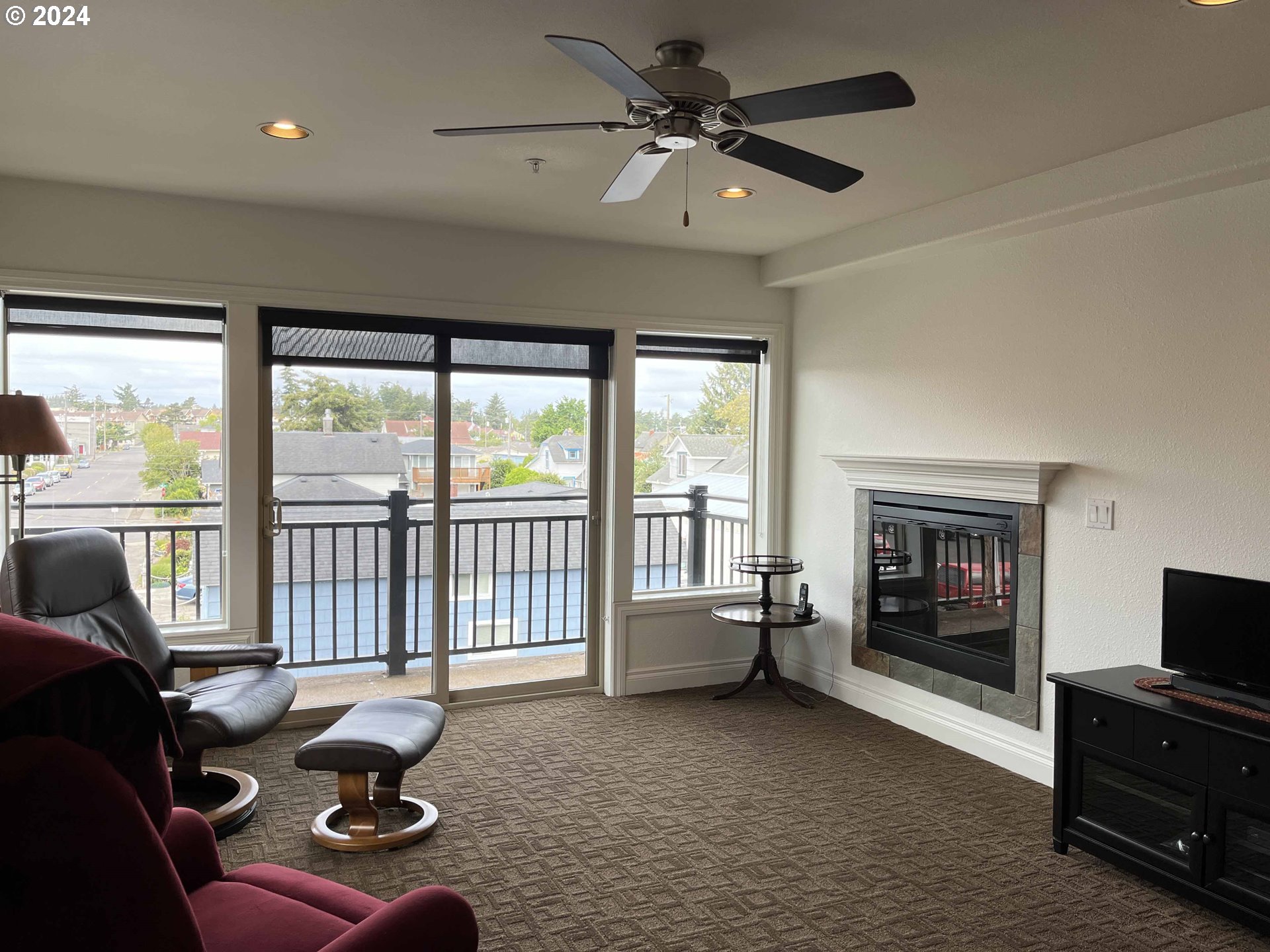 211 Harbor Street, Unit 31 Florence, OR 97439 - Photo 14 of 44 a living room with furniture and a fireplace