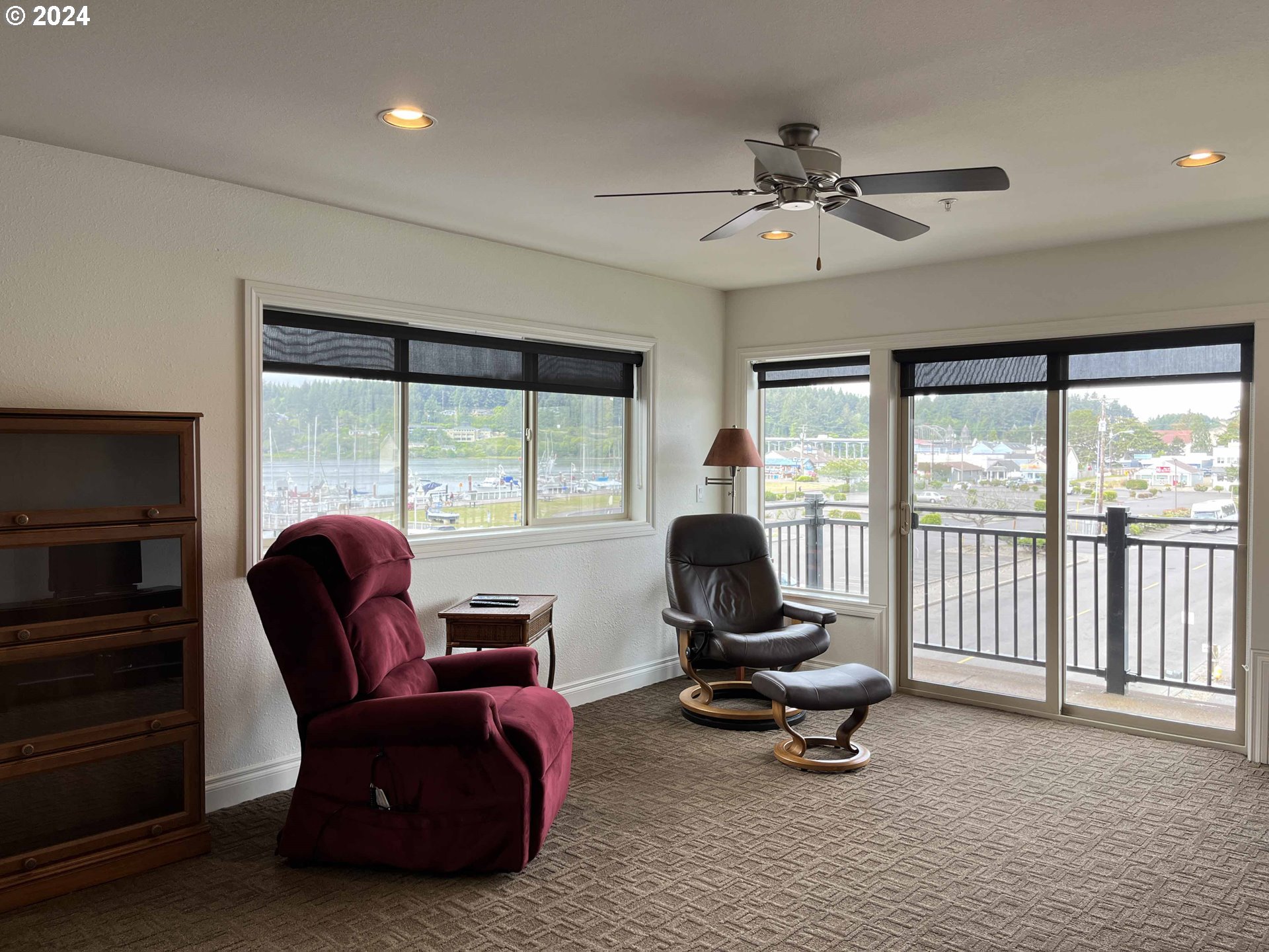 211 Harbor Street, Unit 31 Florence, OR 97439 - Photo 16 of 44 a living room with furniture floor to ceiling window and a ceiling fan