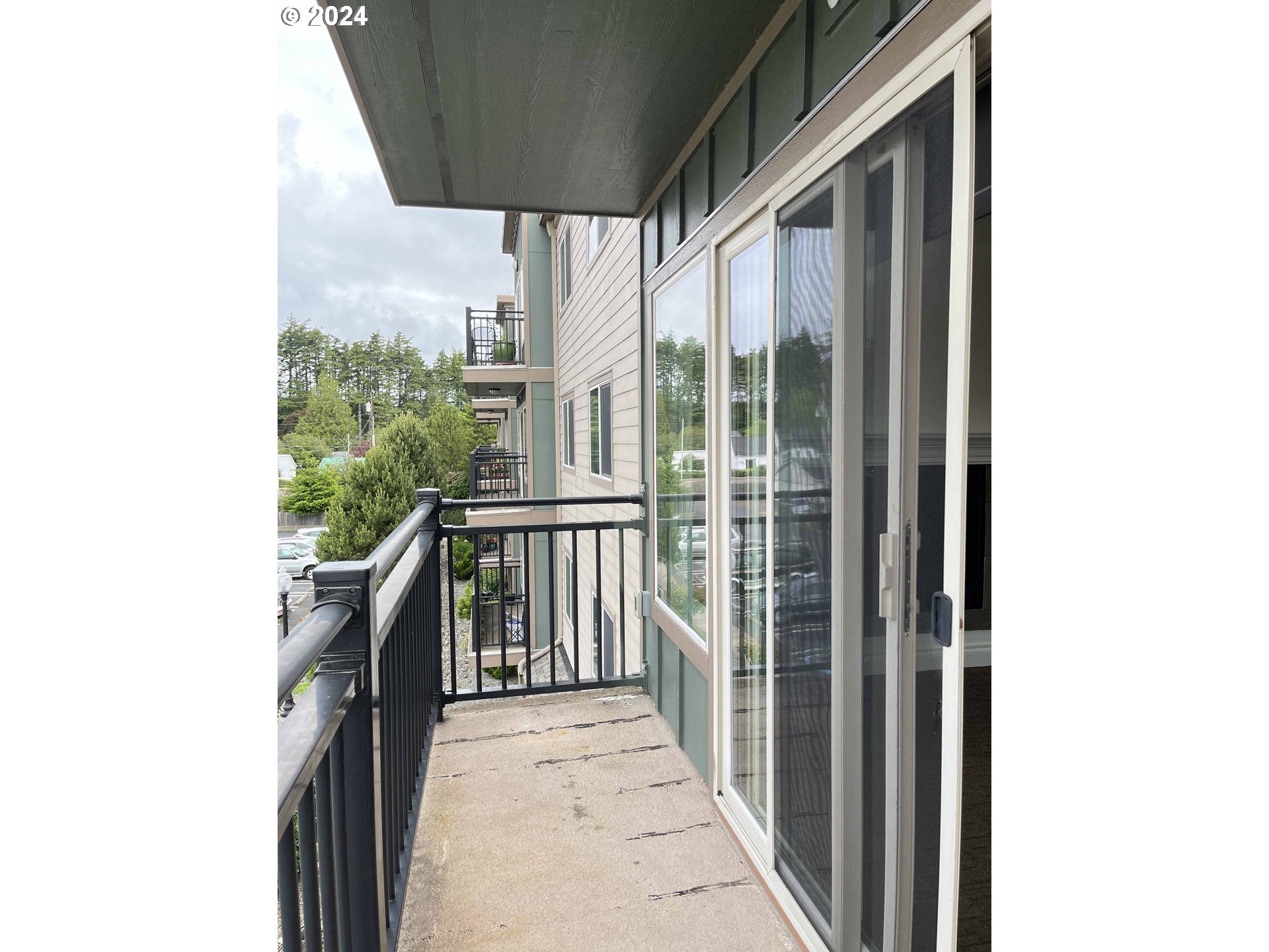 211 Harbor Street, Unit 31 Florence, OR 97439 - Photo 21 of 44 a view of a balcony with furniture and floor to ceiling window