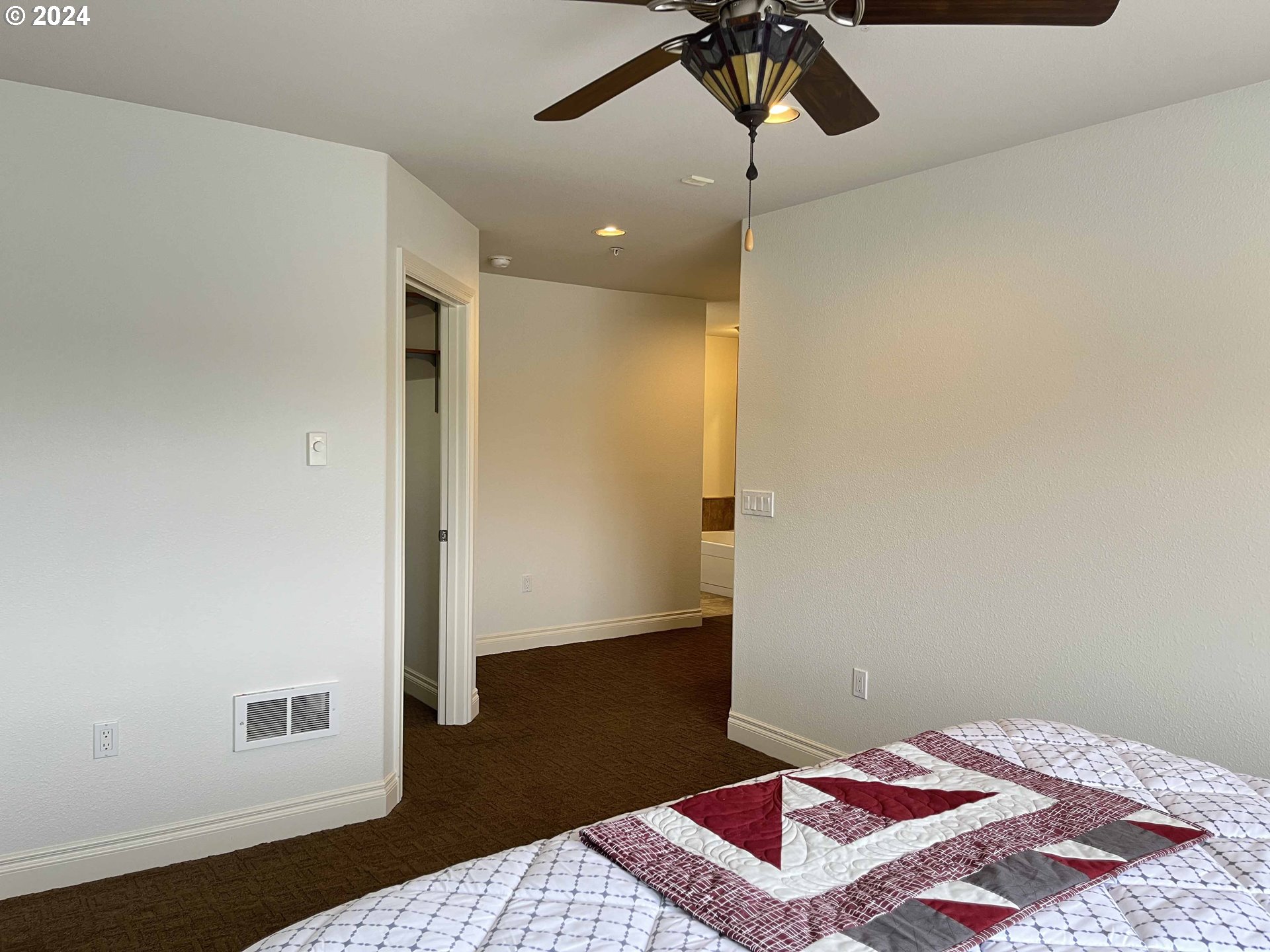 211 Harbor Street, Unit 31 Florence, OR 97439 - Photo 36 of 44 a bedroom with a bed and wooden floor