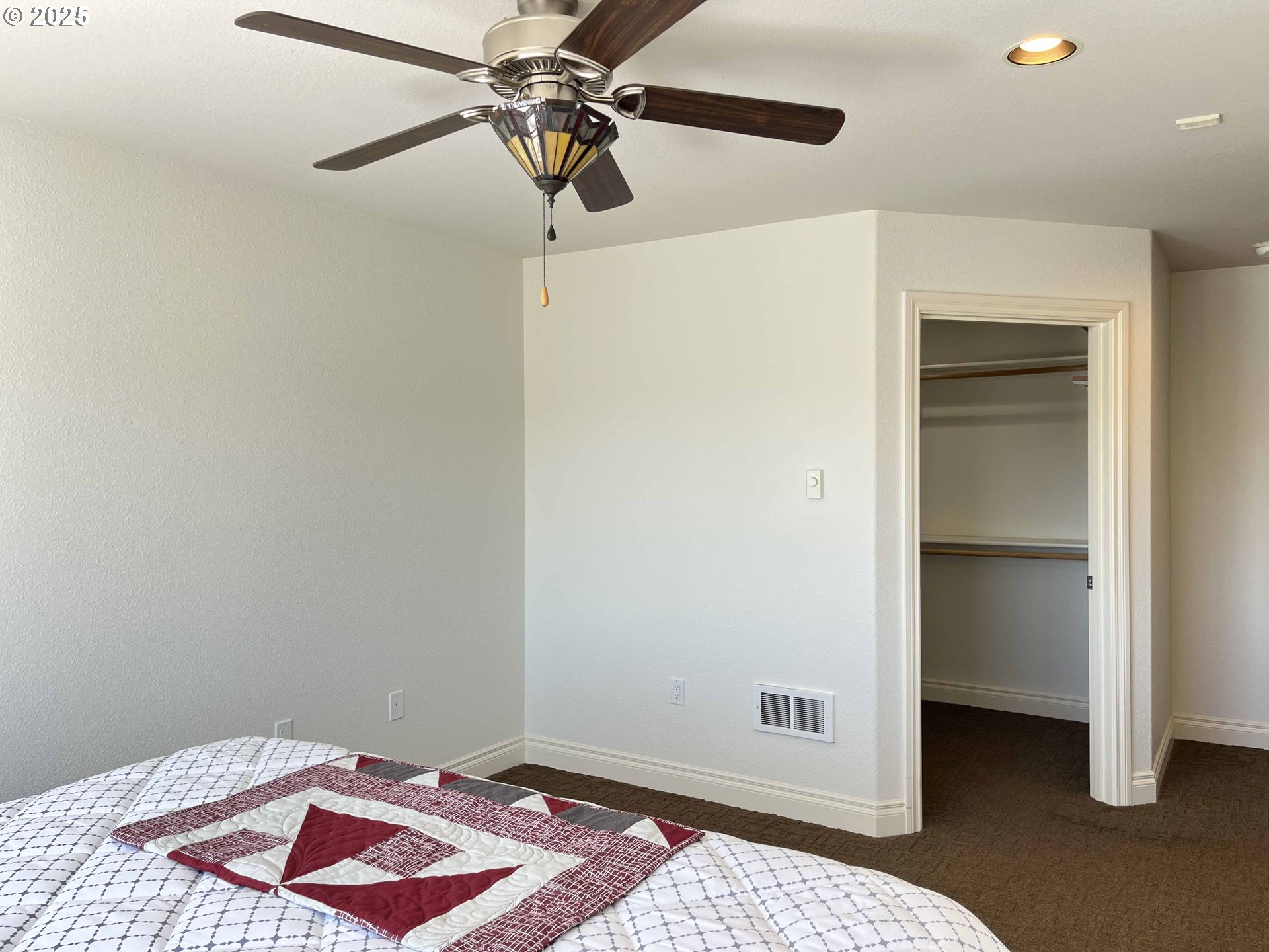 211 Harbor Street, Unit 31 Florence, OR 97439 - Photo 41 of 44 a bedroom with a bed and a ceiling fan