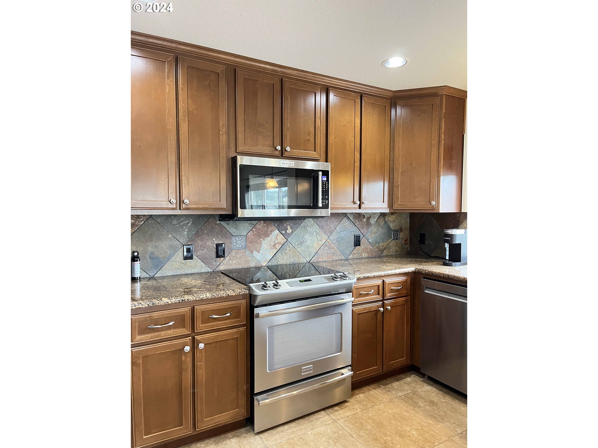 211 Harbor Street, Unit 31 Florence, OR 97439 - Photo 8 of 44 a kitchen with stainless steel appliances granite countertop a stove a sink and a microwave