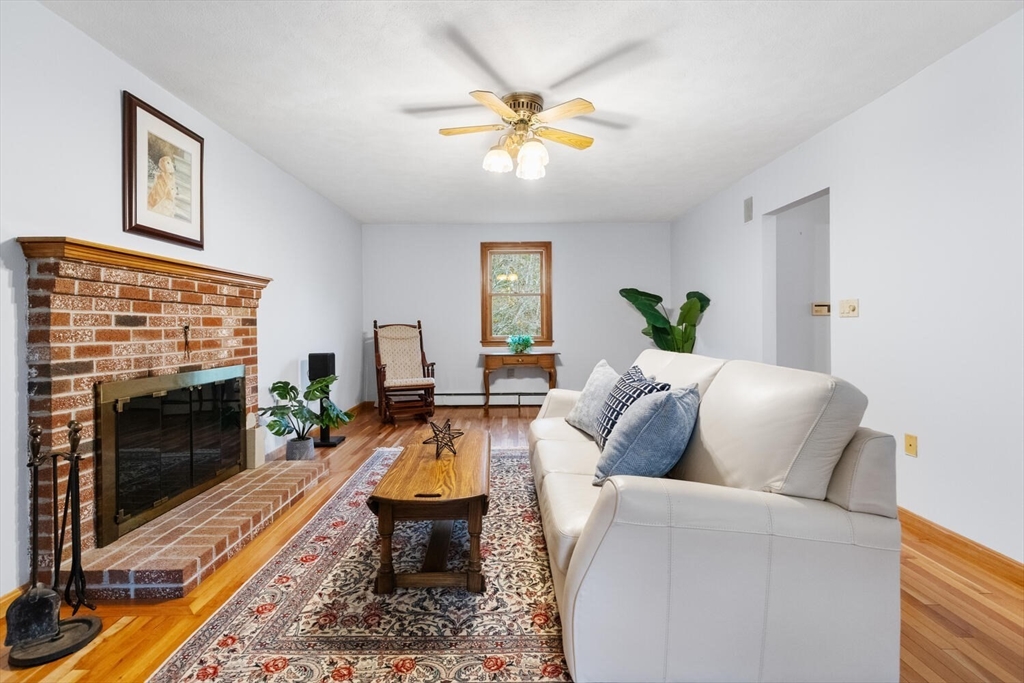 11 Simonds Farm Road Billerica, MA 01862 - Photo 18 of 42 a living room with furniture a fireplace and a flat screen tv