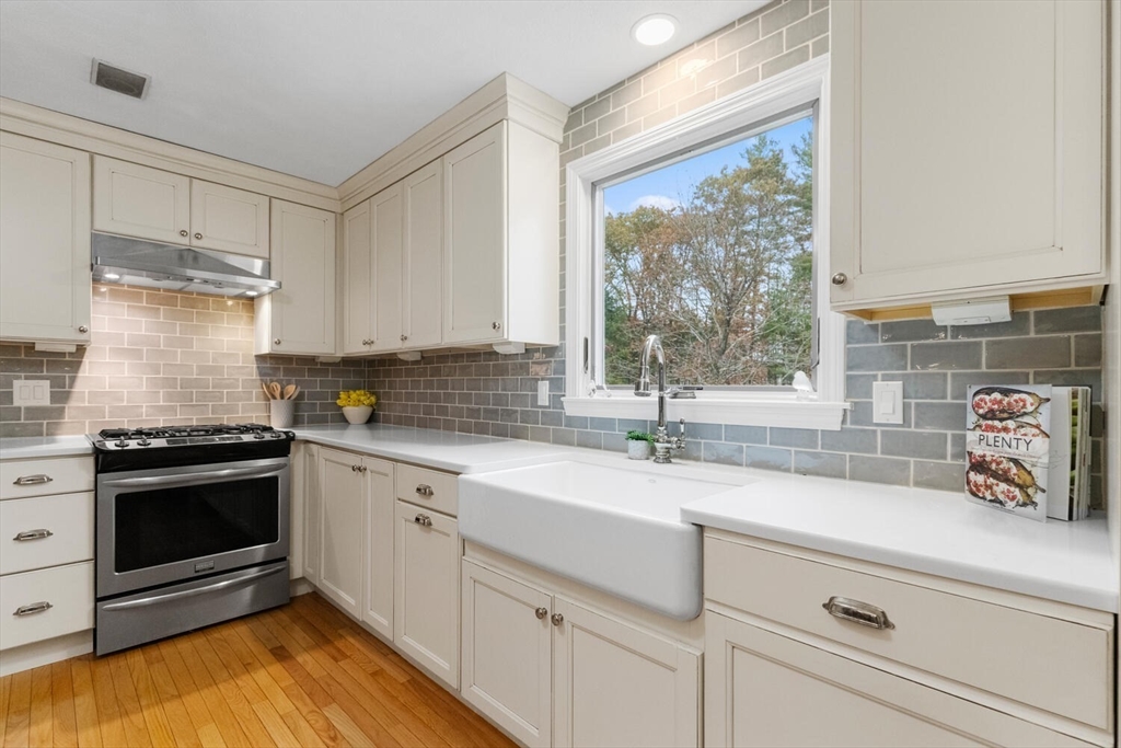 11 Simonds Farm Road Billerica, MA 01862 - Photo 28 of 42 a kitchen with a sink stove and cabinets