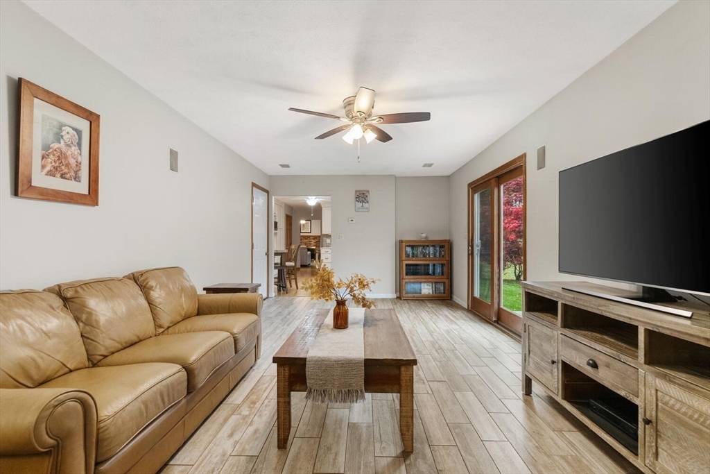 11 Simonds Farm Road Billerica, MA 01862 - Photo 31 of 42 a living room with furniture flat screen tv and wooden floor