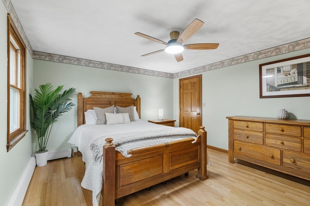 11 Simonds Farm Road Billerica, MA 01862 - Photo 32 of 42 a bedroom with a bed and a chandelier