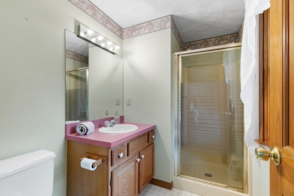 11 Simonds Farm Road Billerica, MA 01862 - Photo 35 of 42 a bathroom with a granite countertop sink a mirror and shower