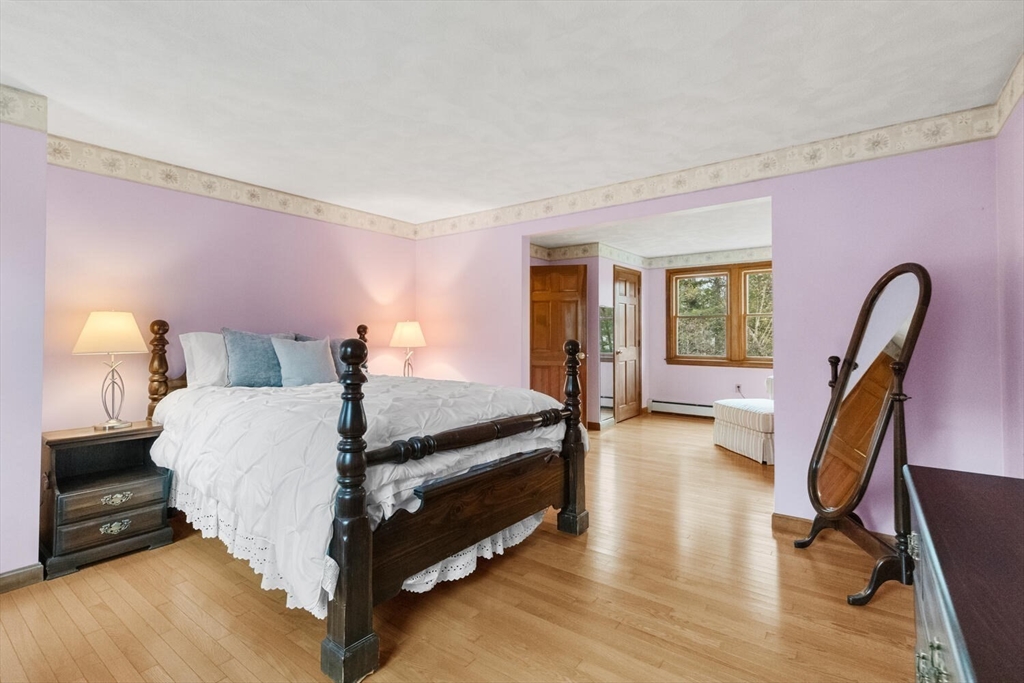 11 Simonds Farm Road Billerica, MA 01862 - Photo 36 of 42 a spacious bedroom with a bed a desk and chair with wooden floor