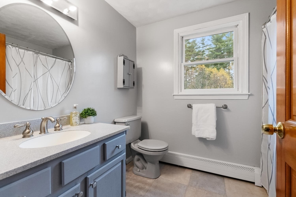 11 Simonds Farm Road Billerica, MA 01862 - Photo 39 of 42 a bathroom with a granite countertop sink toilet and a mirror