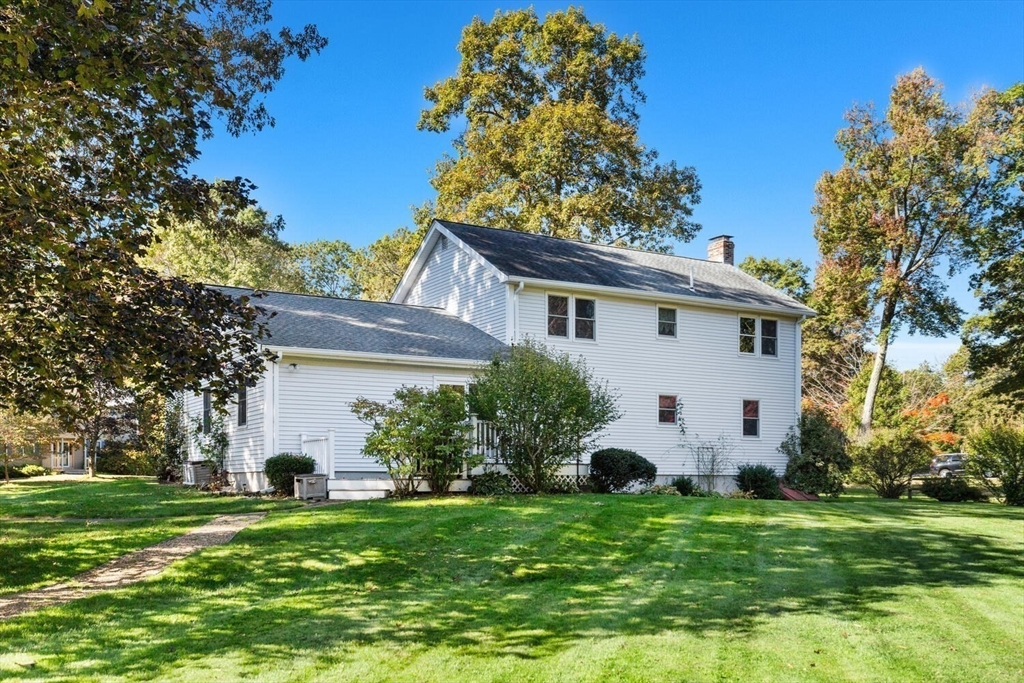 11 Simonds Farm Road Billerica, MA 01862 - Photo 41 of 42 a view of a white house with a yard and plants