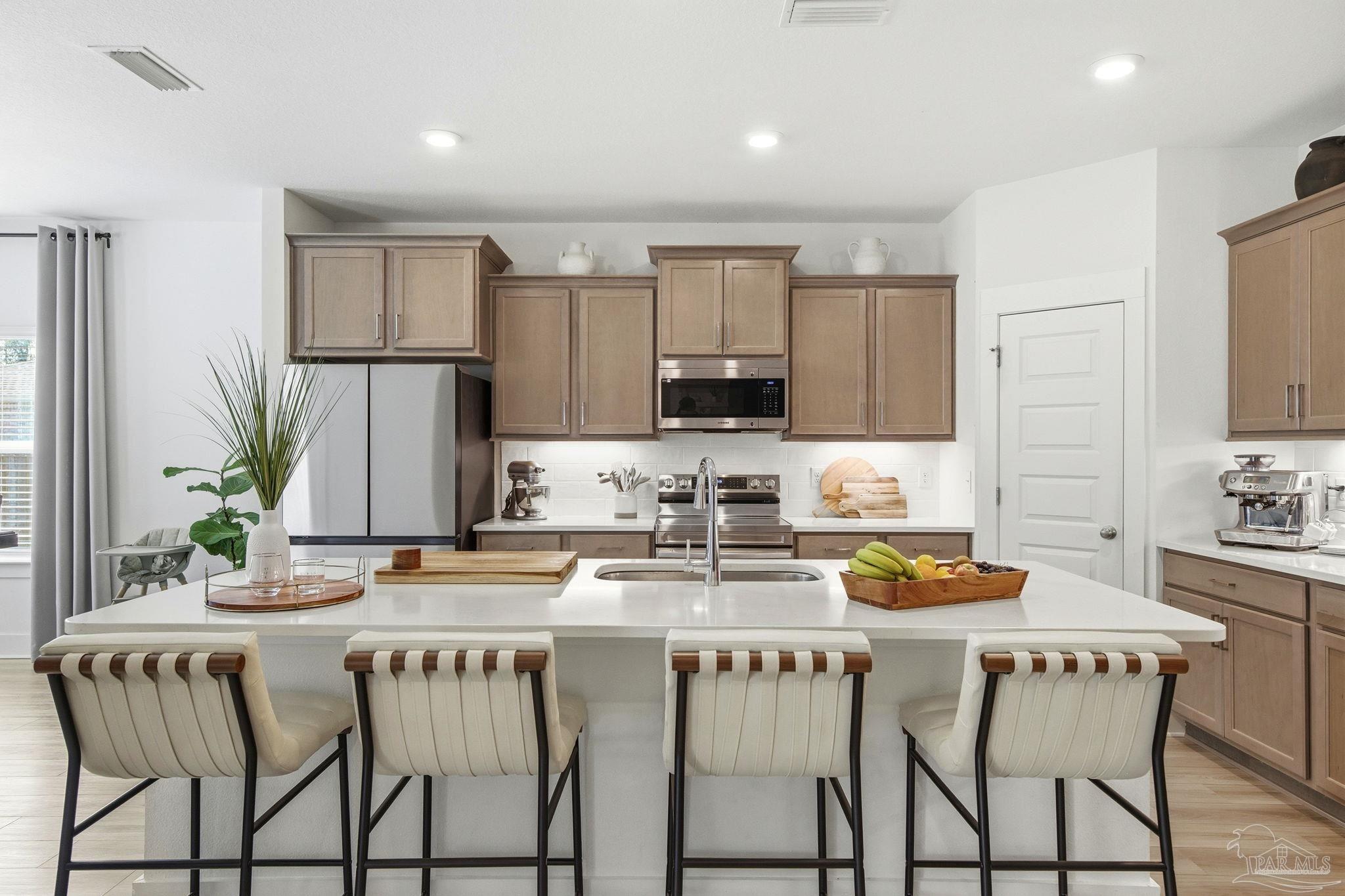 6228 Dry Crk Road Molino, FL 32577 - Photo 13 of 64 a kitchen with stainless steel appliances granite countertop a white cabinets and a stove