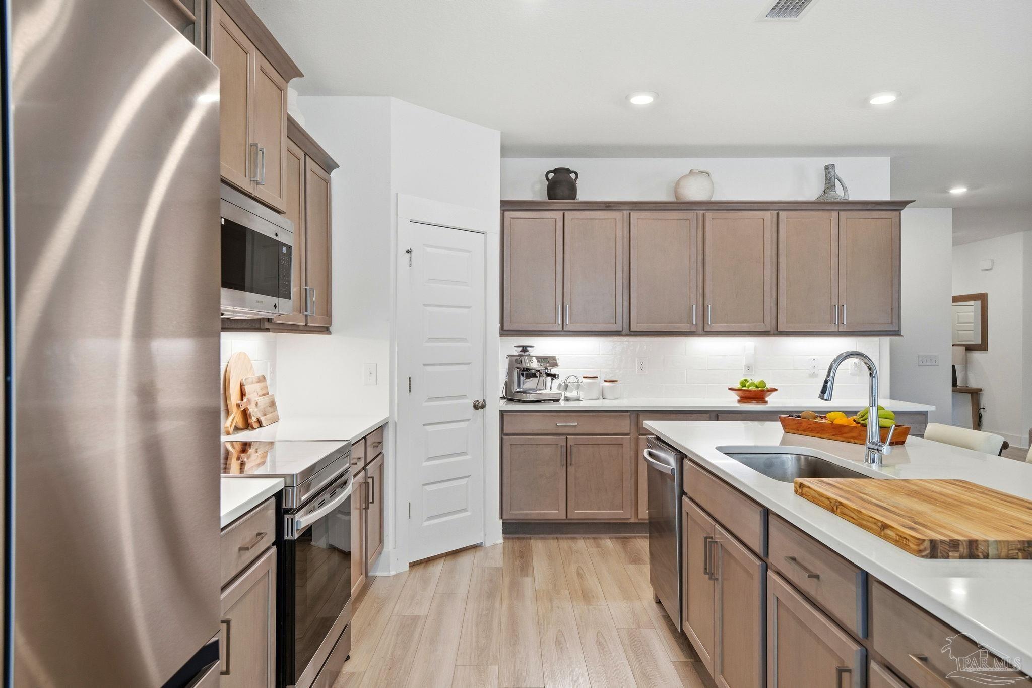 6228 Dry Crk Road Molino, FL 32577 - Photo 14 of 64 a kitchen with stainless steel appliances granite countertop a sink stove and refrigerator